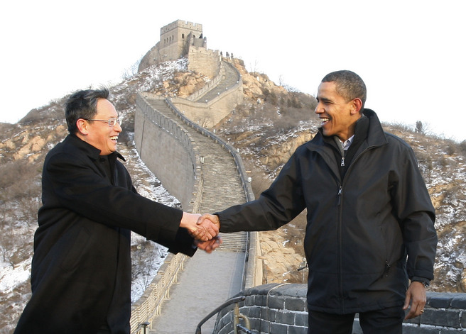 Two serious-looking persons shaking hands